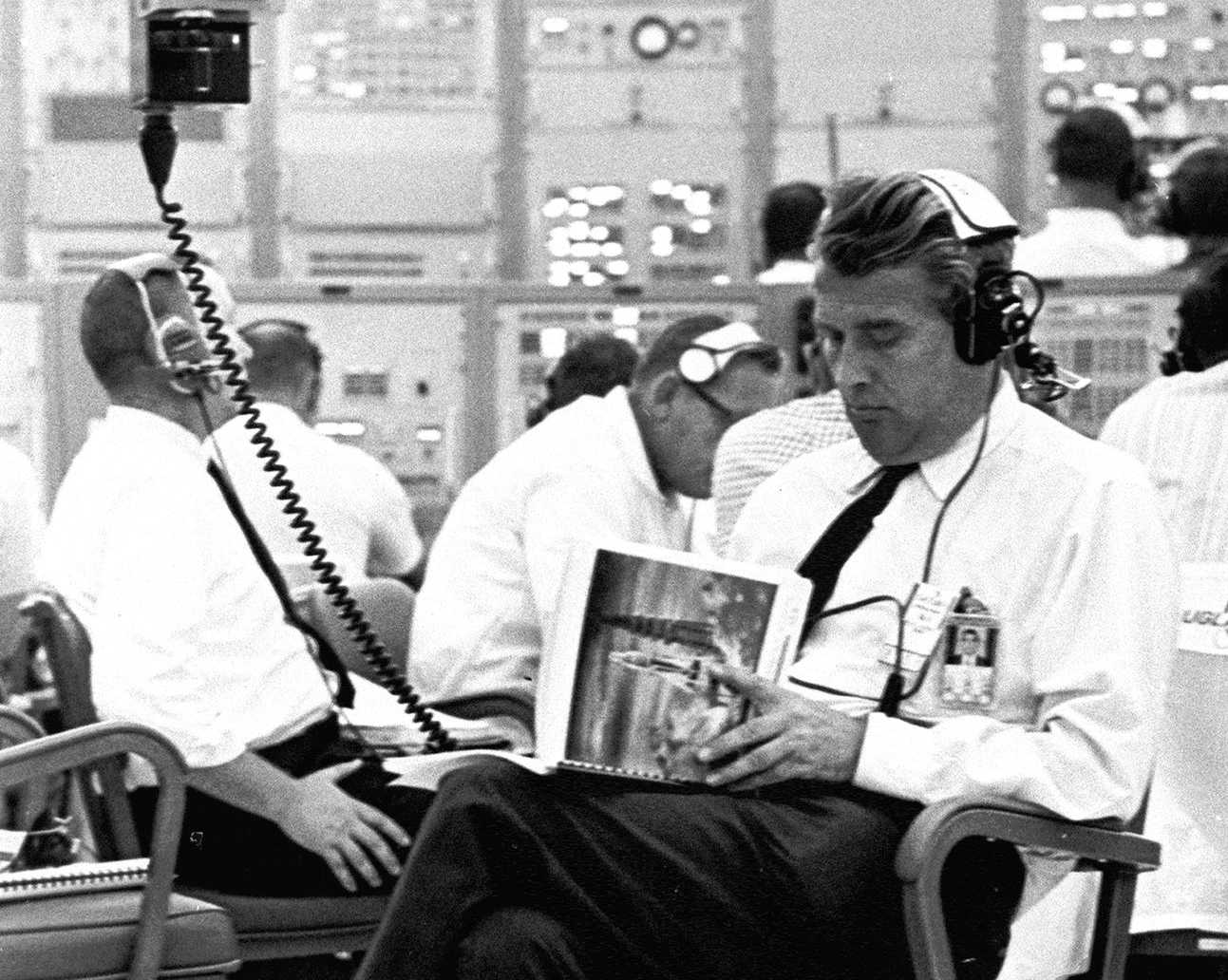 NASA administrator reading a manual 1960s