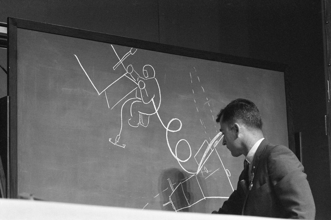 NASA engineer drawing on chalk board 1960s