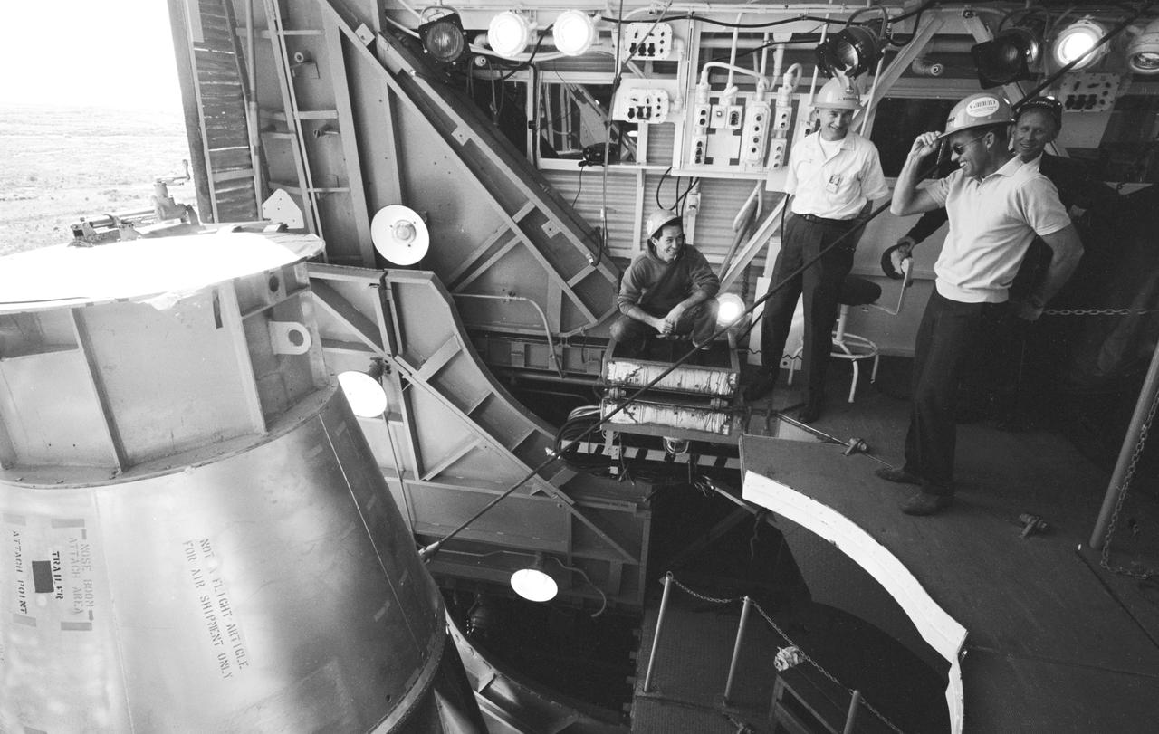 NASA astronaut tours capsule on launchpad with admins and technicians 1960s