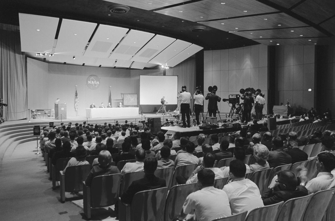 NASA press conference broadcast in full auditorium 1960s
