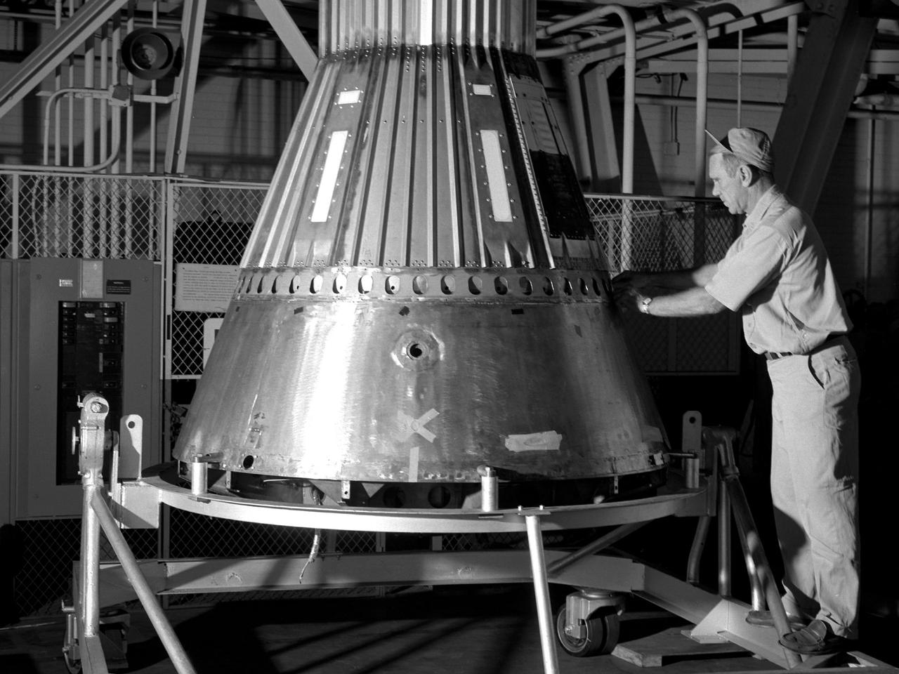 NASA technician working on capsule 1960s