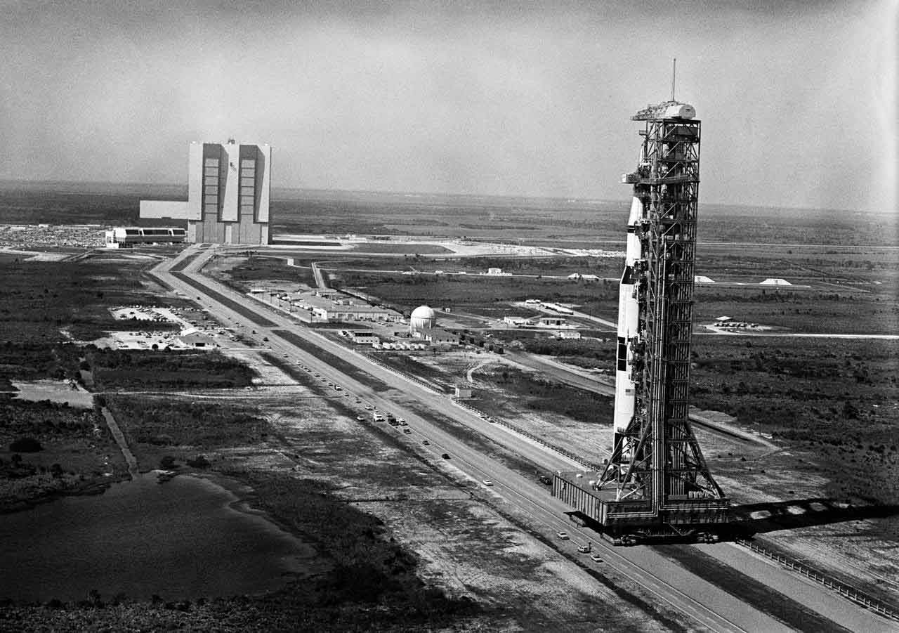 NASA Rocket Hanger in background rocket on launchpad in foreground 1960s