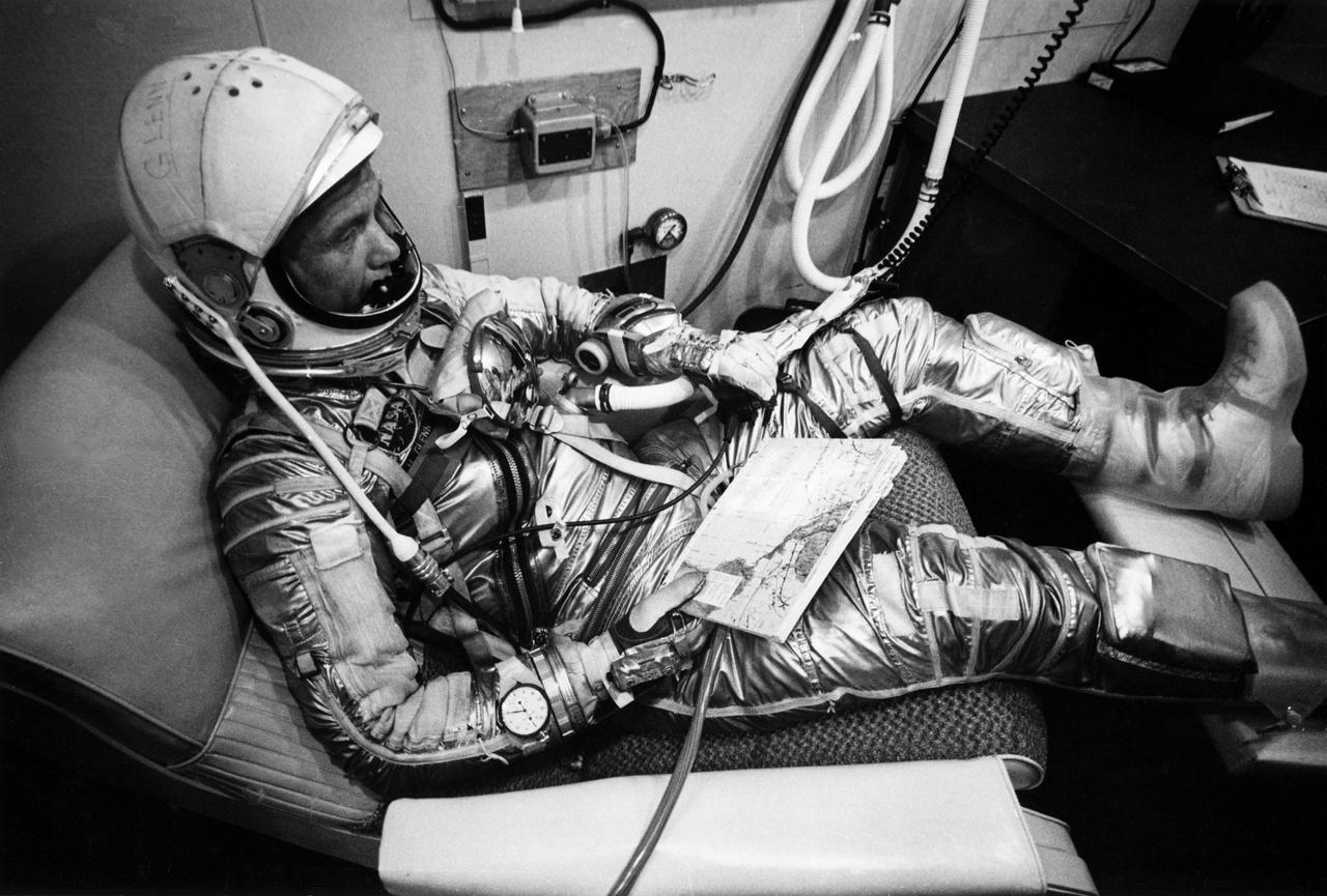 NASA Astronaut in waiting area with map 1960s