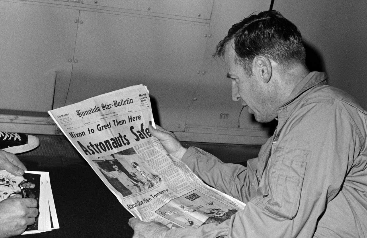 NASA astronaut reads newspaper 1970